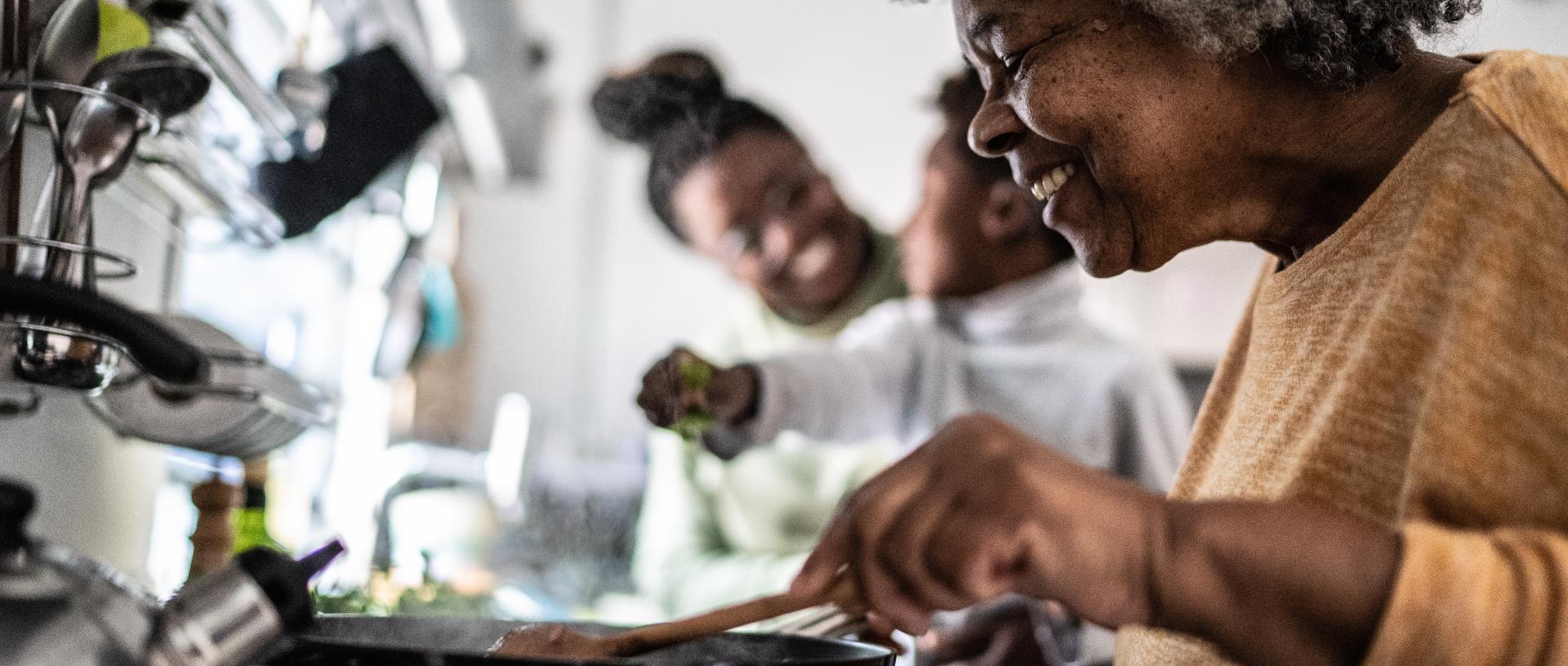 Woman cooking with family