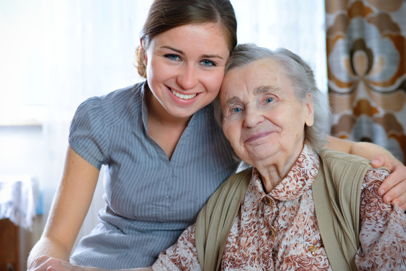 younger owman hugging older woman